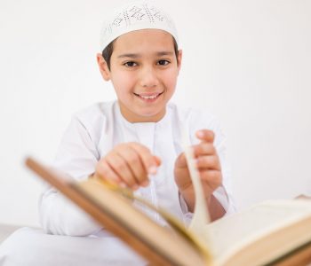 Happy kids reading Koran